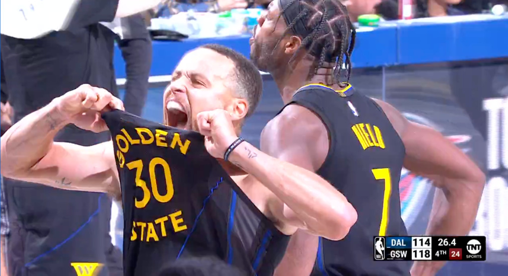 Curry holds up his jersey after his dagger 3-pointer.